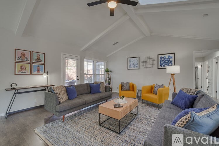 A living room with a grey couch and a brown coffee table.