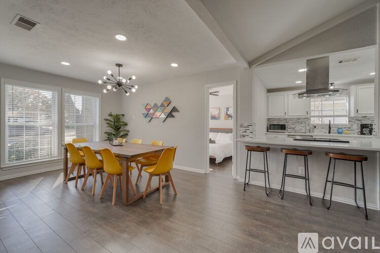 A modern kitchen with a dining table and chairs.