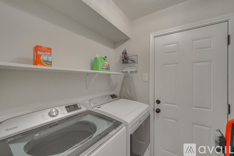 A small laundry room with a washer and dryer.