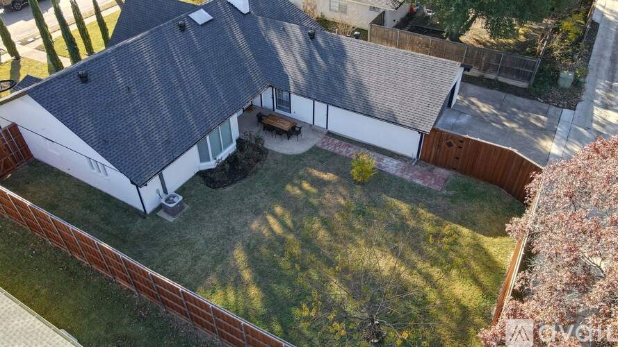 A house with a grey roof and a brown fence.