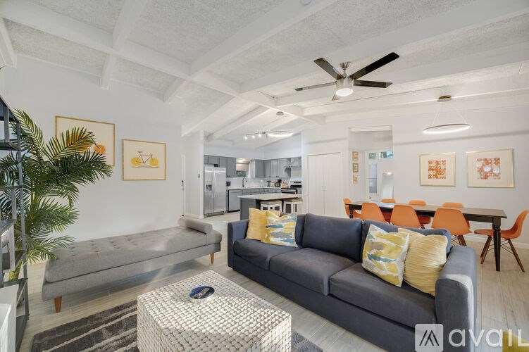 A living room with a grey couch and a coffee table.