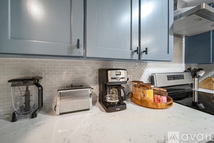 A kitchen counter with a toaster, blender, and coffee maker.