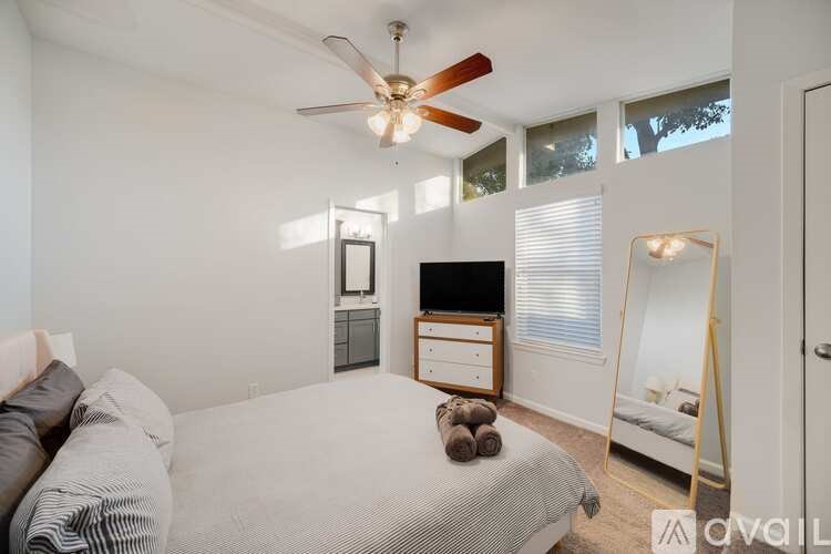 A bedroom with a bed, dresser, and mirror.