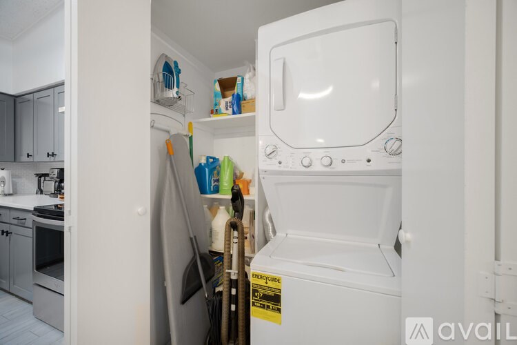 A white refrigerator with a yellow caution sign on the door.