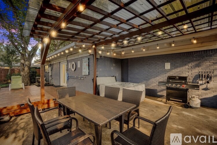 A patio with a table and chairs is set up for an outdoor gathering.