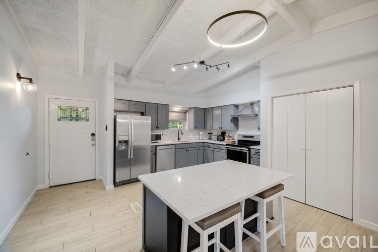 A modern kitchen with a large island in the center.