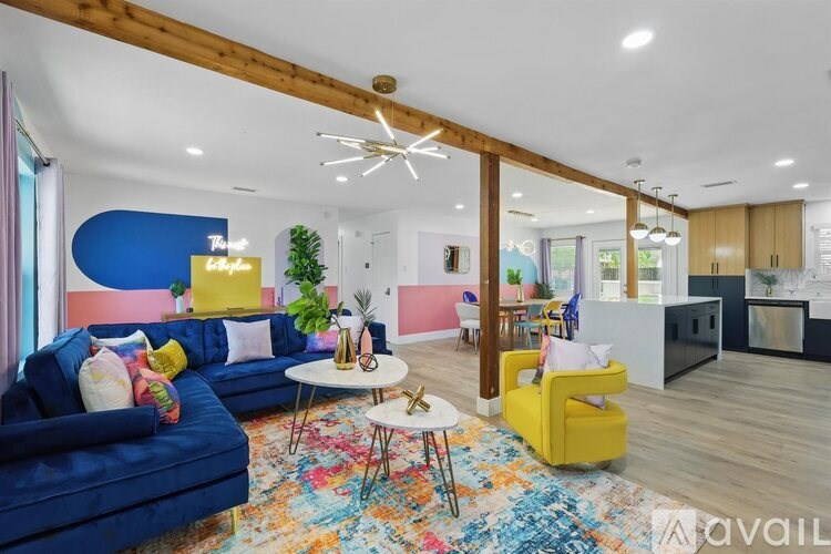 A living room with a blue sofa and a yellow chair.