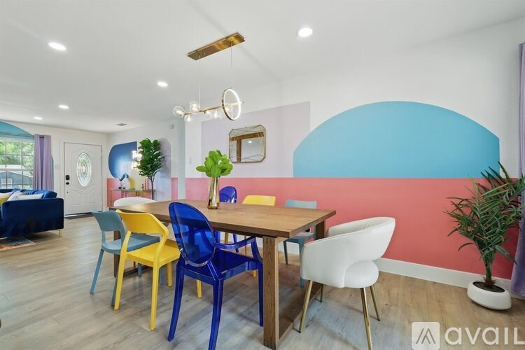 A dining room with a wooden table and chairs.