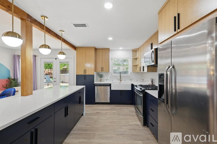 A modern kitchen with wooden cabinets and stainless steel appliances.