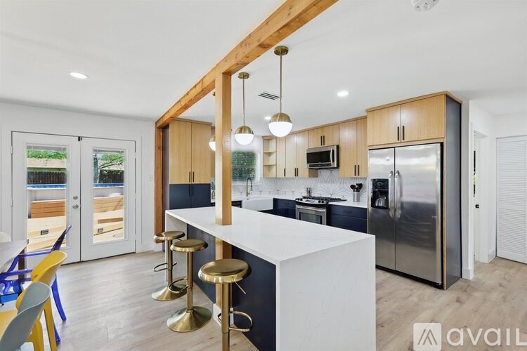 A modern kitchen with a white countertop and wooden cabinets.