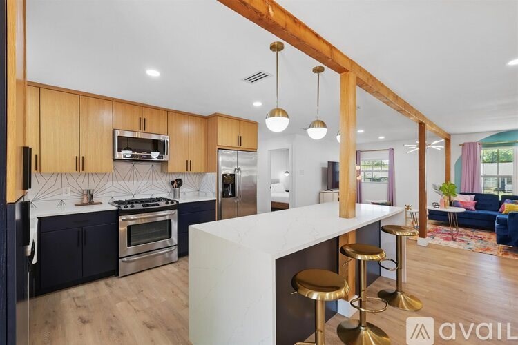 A modern kitchen with dark blue cabinets and a white island.