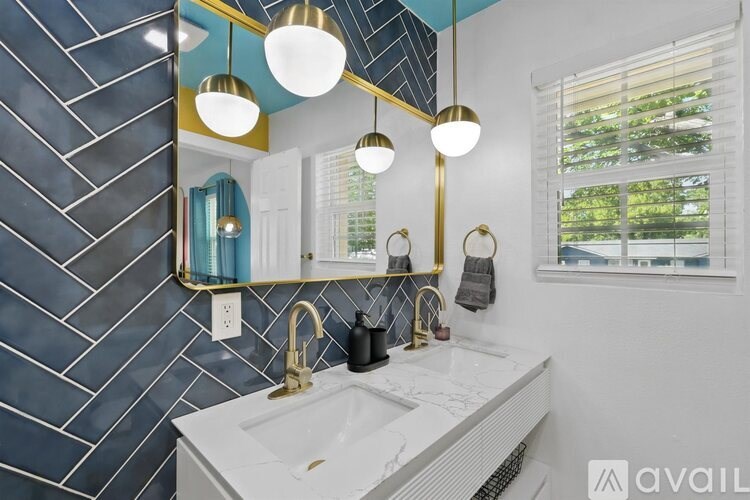 A bathroom with a white sink and a mirror above it.