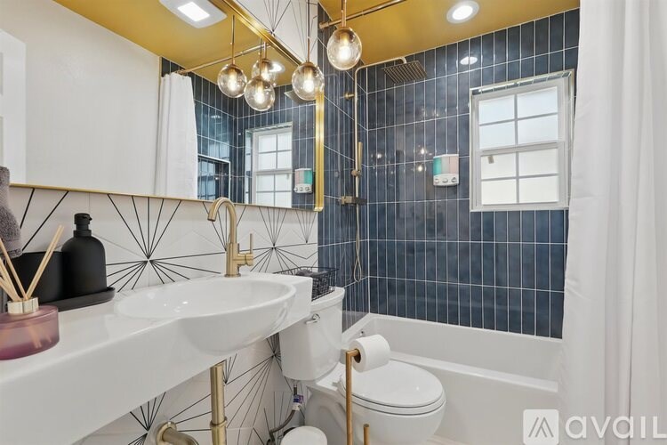 A bathroom with a white sink and a white toilet.