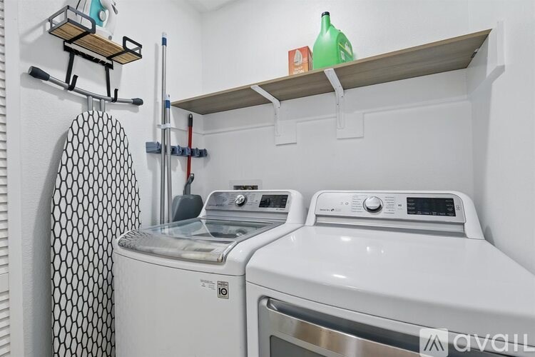 A small laundry room with a washer and dryer.