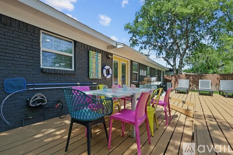 A wooden deck with a table and chairs.
