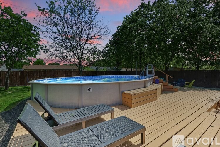 A wooden deck with a hot tub and seating area.