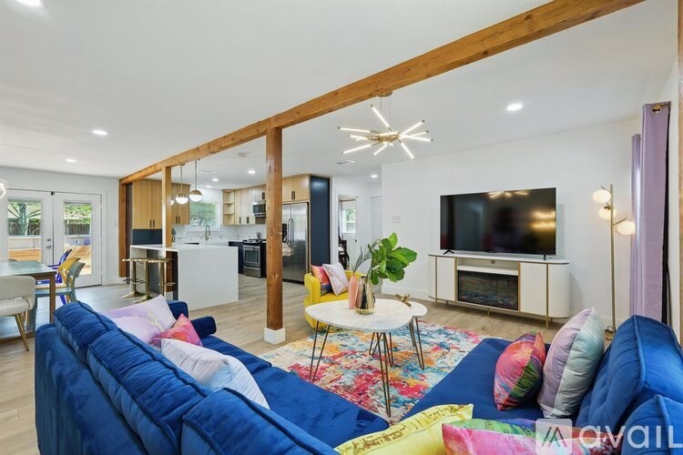 A living room with a blue couch and a television.