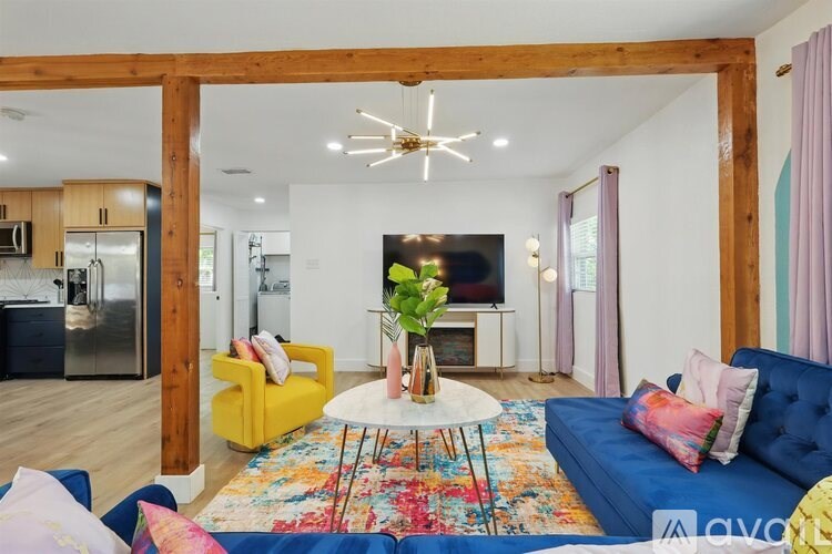 A living room with a yellow chair and a blue couch.