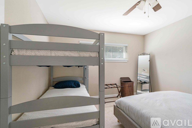 A bedroom with a bunk bed and a single bed.