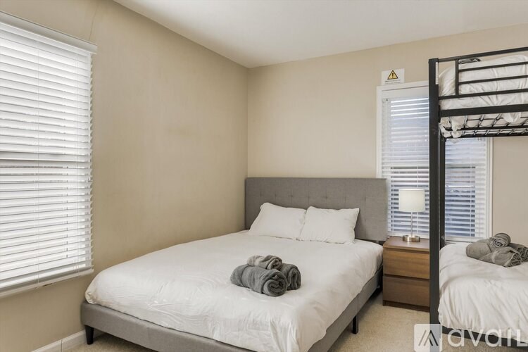 A bedroom with a large bed and a bunk bed.