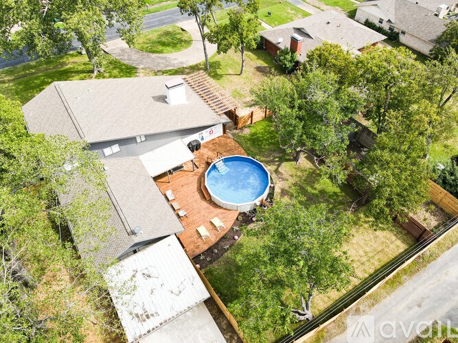 A backyard with a pool and deck.