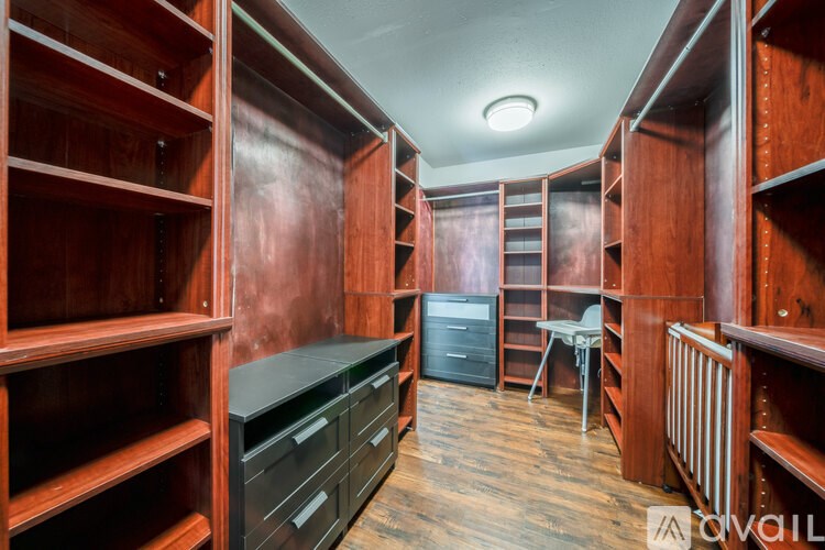 A room with wooden shelves and drawers.