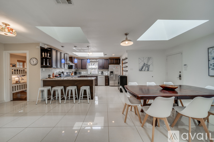 A modern kitchen with a dining table and chairs.