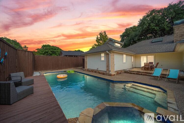 A backyard with a pool and deck.