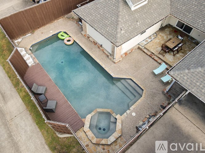 A backyard with a pool and a hot tub.