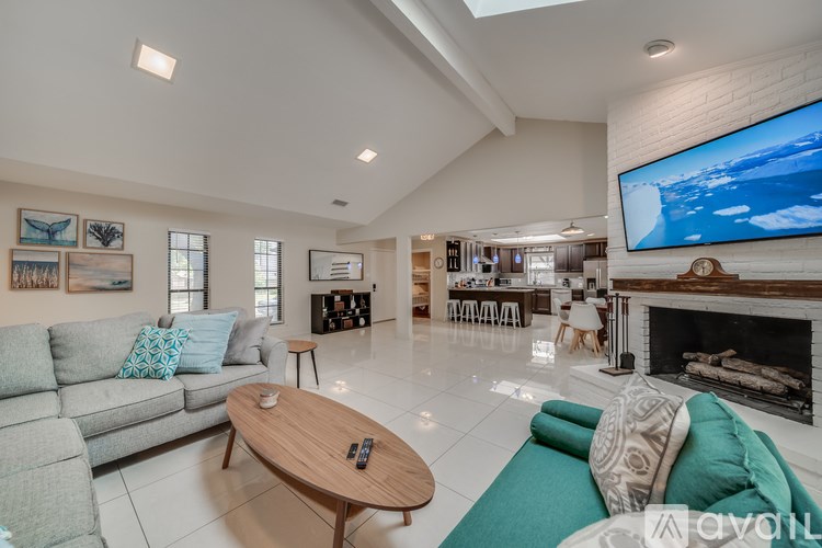 A living room with a grey couch and a wooden coffee table.