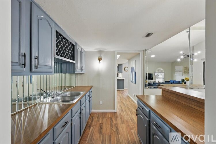 A kitchen with wooden floors and a sink.