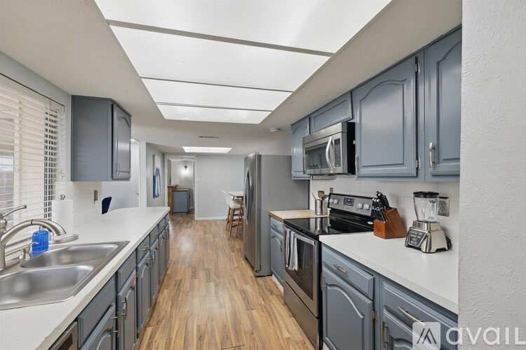 A kitchen with wooden floors and modern appliances.