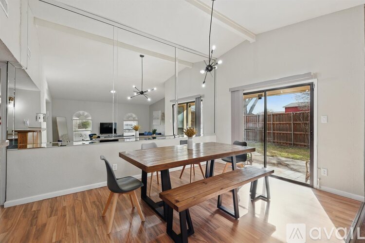 A modern dining room with a wooden table and bench.