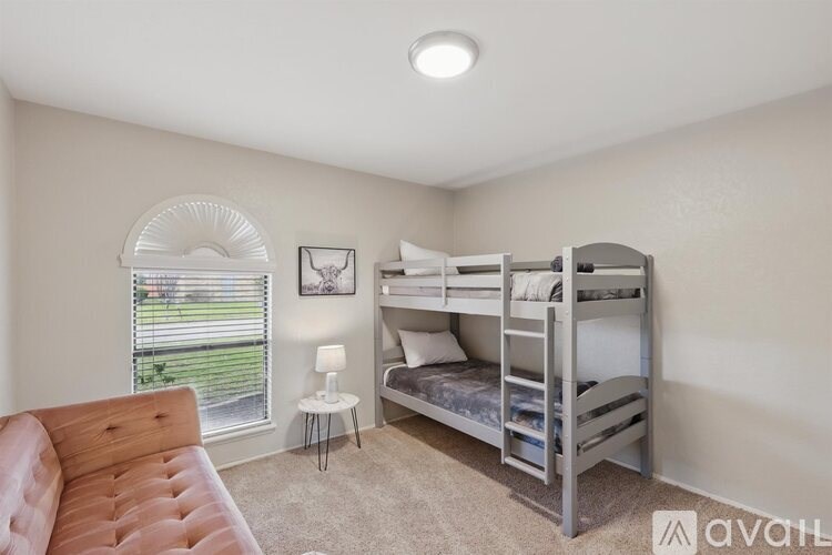 A room with a bunk bed and a couch.