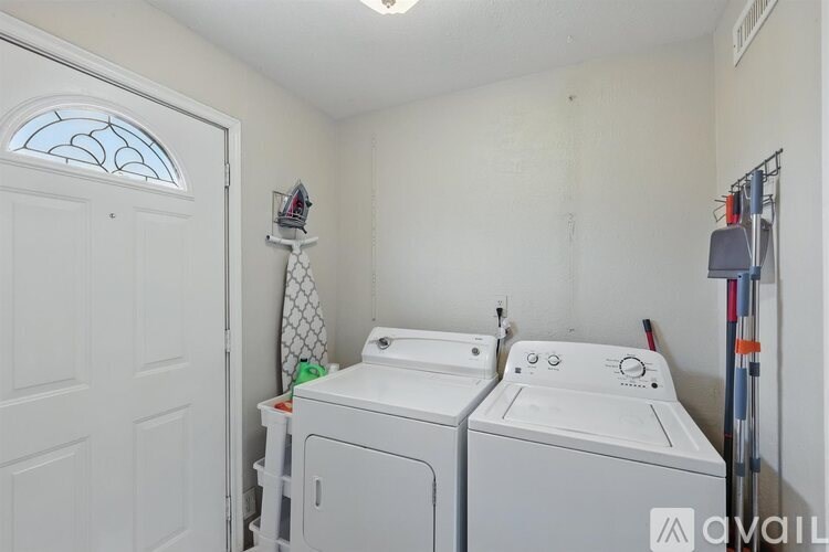 A small laundry room with a washer and dryer.