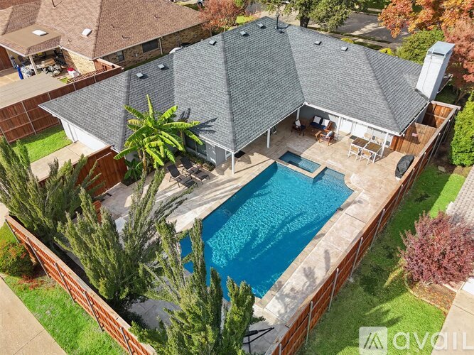A backyard with a pool and a patio area.