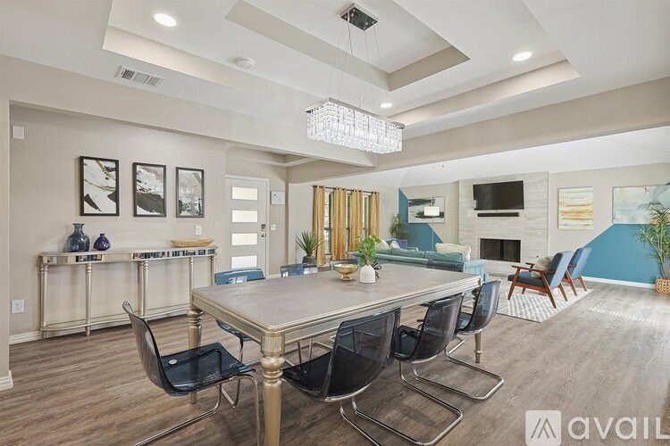 A dining room with a table and chairs.
