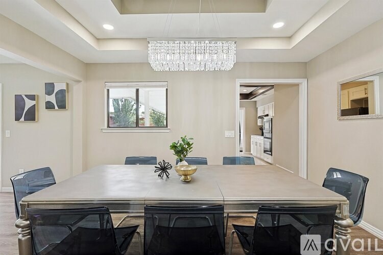 A dining room with a table set for six.