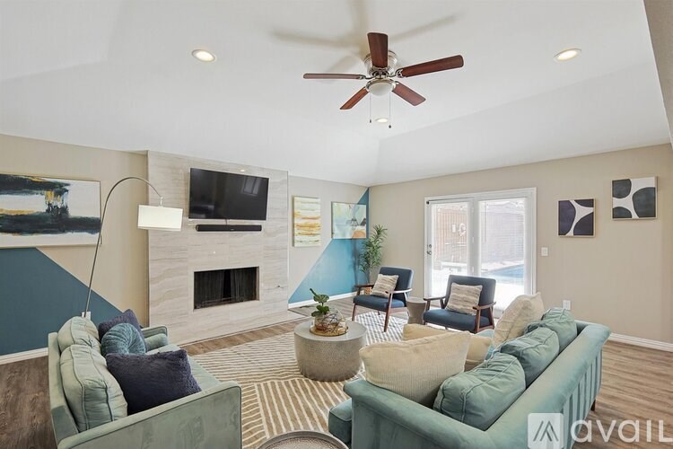 A living room with a fireplace and a television.