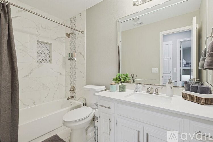 A bathroom with a white toilet and a white sink.