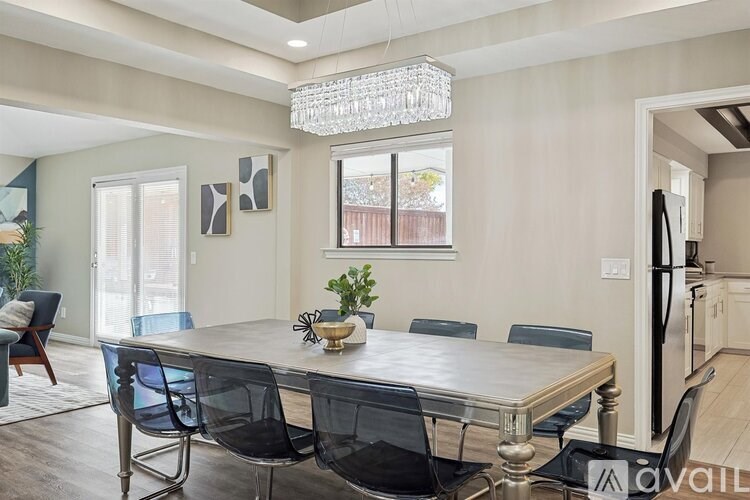 A dining room with a table and chairs.