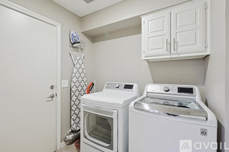 A white oven and washing machine in a small kitchen.