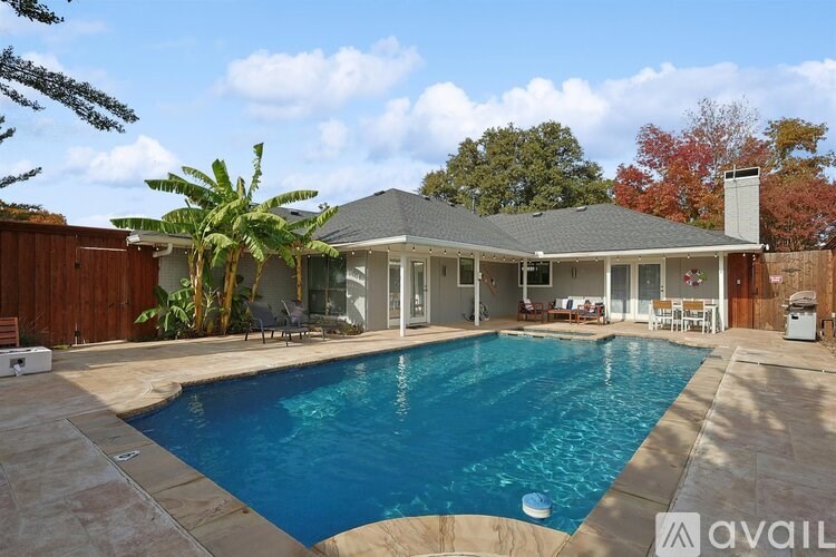 A house with a pool in the backyard.