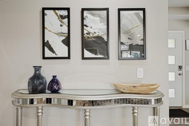 A table with two vases and a bowl on it.