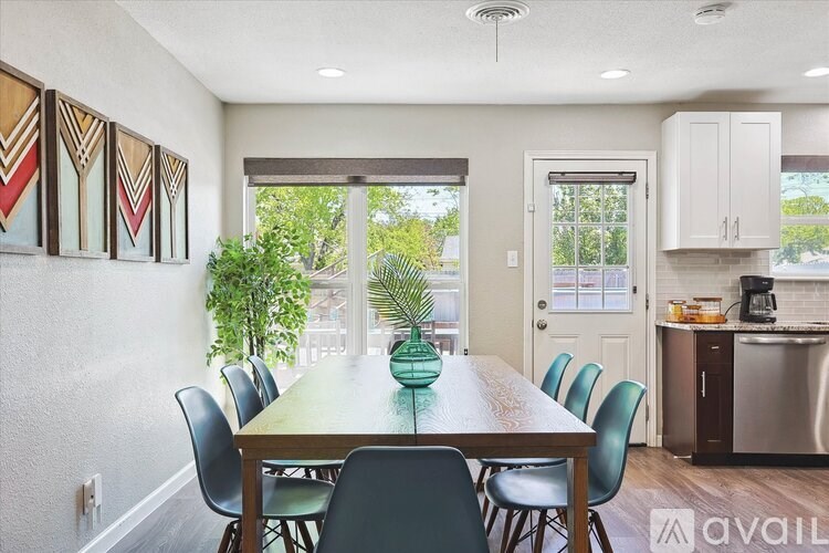 A dining room with a wooden table and chairs.