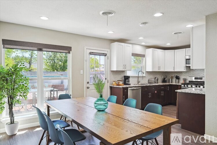 A dining room with a wooden table and blue chairs.
