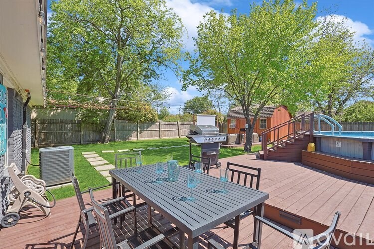 A backyard with a table and chairs.