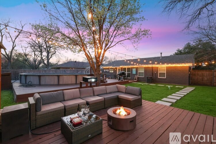 A backyard with a fire pit and seating area.