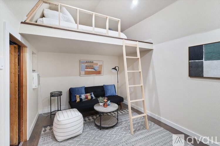 A room with a bunk bed and a chair.