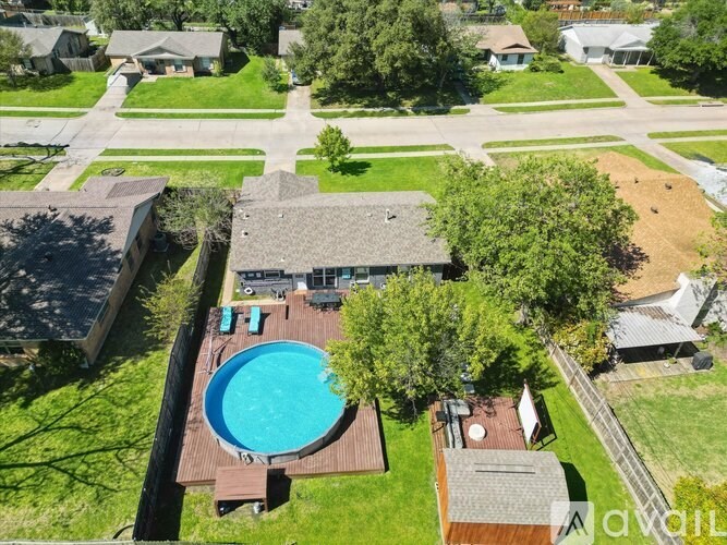 A bird's eye view of a house with a pool in the backyard.